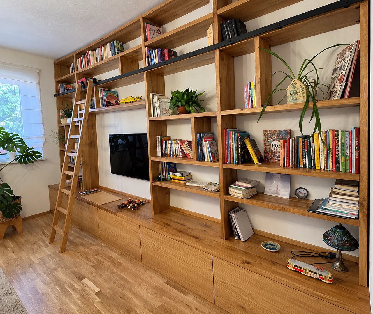 Libreria in legno su misura, con scala e vani a tutta parete